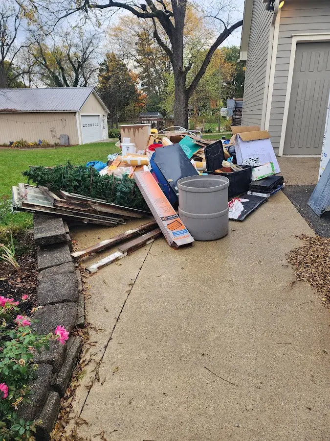 Dumpster being loaded with debris for Estate Cleanout Dumpster Rental in Paducah
